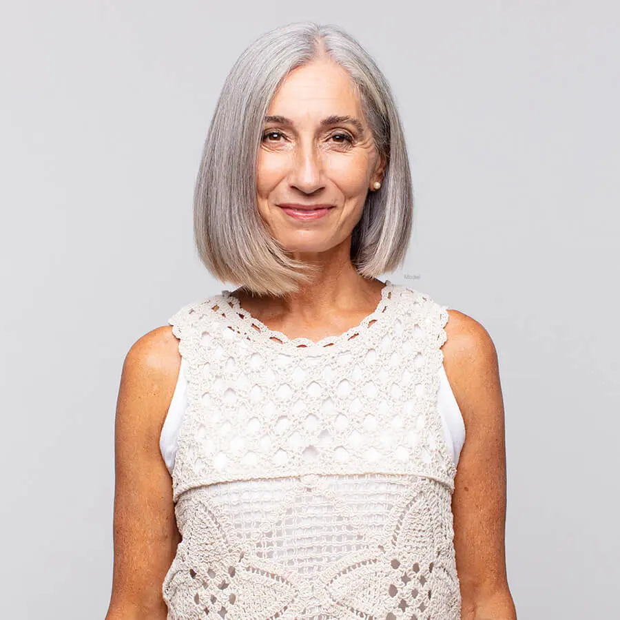Gray haired woman in a lace shirt