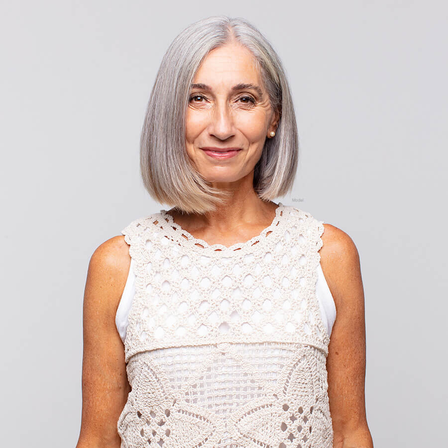 Gray haired woman in a lace shirt