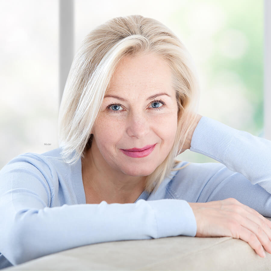 Mature woman leaning on couch